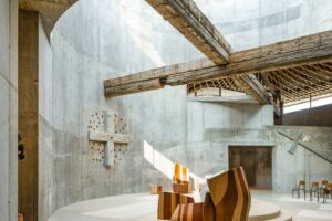 Two wooden beams form a cross above the altar