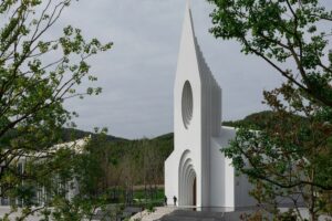 The church stands out against a mountainous backdrop